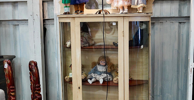 Vintage porcelain doll girl with blue eyes with flowing curly golden hair